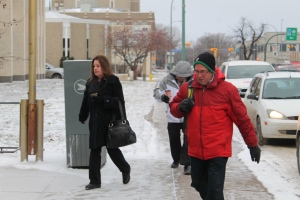 Former SaskTel managers Joan Yasinowski, Barry Richardson and Dan Crites are seen outside court of Queen's Bench in Regina on Nov. 26, 2014.