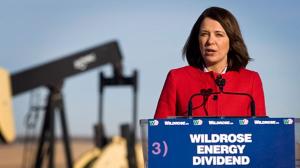 Wildrose Leader Danielle Smith makes a campaign stop with an oil and gas pumpjack the background near Cremona, Alta., Monday, April 2, 2012. (Jeff McIntosh / THE CANADIAN PRESS)