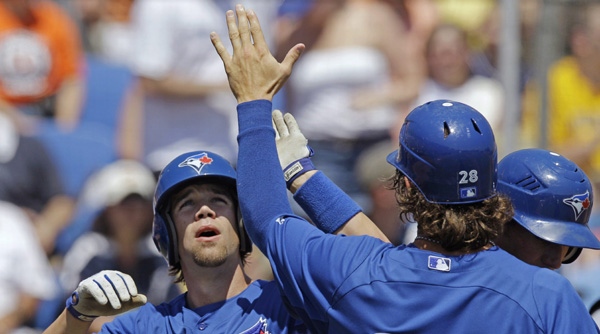 Toronto Blue Jays' Colby Rasmus (28) greets Robbie Schimpf, left, after Schimpf hit a pinch-hit, fifth-inning grand slam during the Blue Jays' 13-8 victory over the Detroit Tigers in a spring training baseball game in Dunedin, Fla., Tuesday, April 3, 2012. (AP Photo/Kathy Willens)