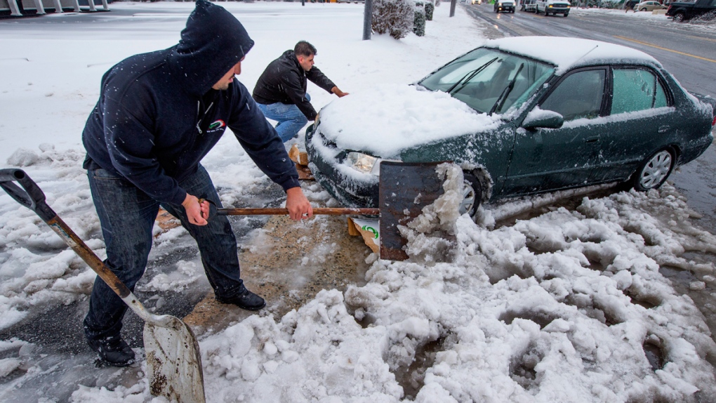 Digging out a snowbound car in Greensboro, N.C.