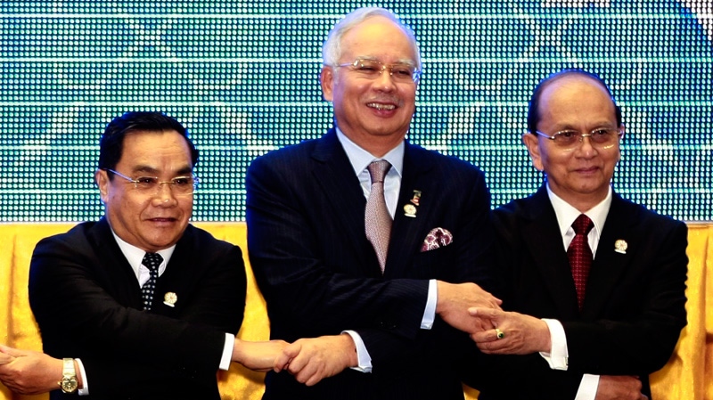 Leaders from the Association of Southeast Asian Nations (ASEAN) from left, Laos' Prime Minister Thongsing Thammavong, Malaysia's Prime Minister Najib Razak and Myanmar's President Thein Sein join hands during a group photo at the opening ceremony of the 20th ASEAN Summit in Phnom Penh, Cambodia Tuesday, April 3, 2012. (AP / Apichart Weerawong)