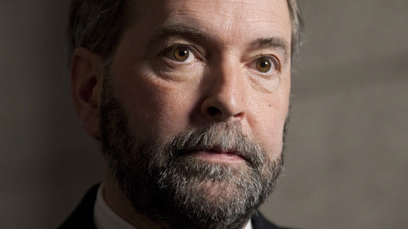 NDP leader Thomas Mulcair speaks with the media following the party caucus meeting on Parliament Hill 