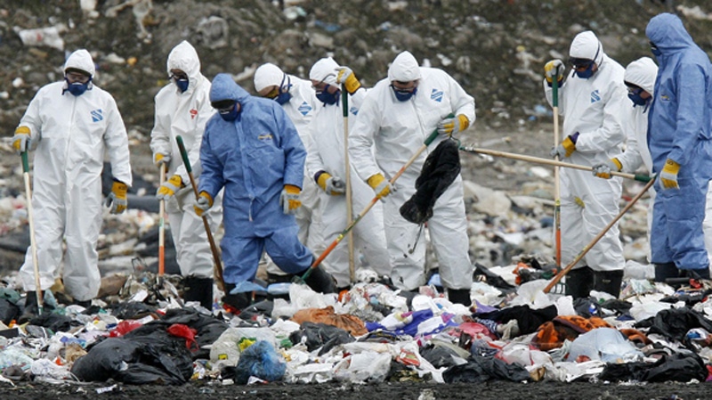 Ontario Provincial Police officers search the Oxford County landfill site Tuesday, April 21, 2009, for any clues in the abduction of Victoria Stafford. (Dave Chidley / THE CANADIAN PRESS)