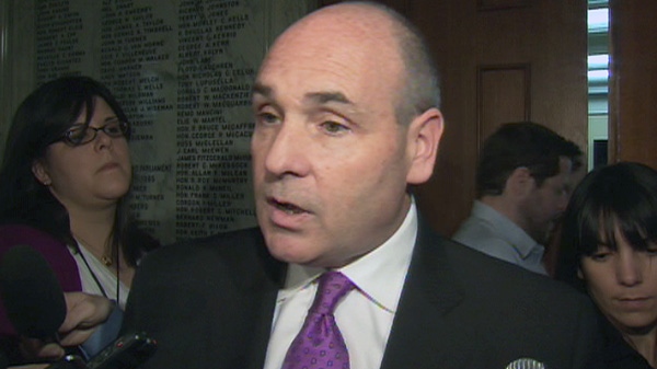 Former Ontario Health Minister George Smitherman speaks to reporters at Queen's Park in Toronto on Wednesday, April 4, 2012