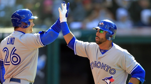 Toronto Blue Jays' Jose Bautista is greeted by Adam Lind (26) after Bautista's solo home run off Cleveland Indians starting pitcher Justin Masterson in the fourth inning of an opening day baseball game, Thursday, April 5, 2012, in Cleveland. (AP Photo/Mark Duncan)