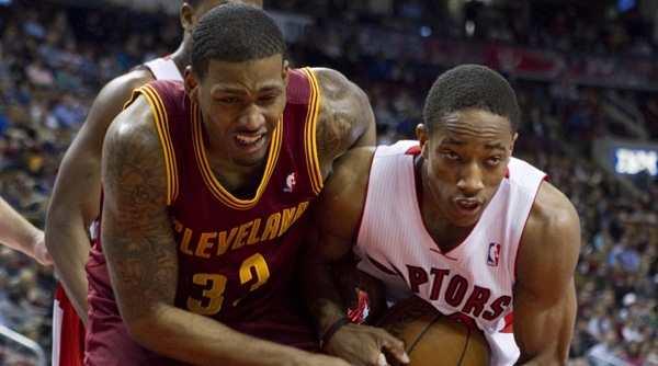 Toronto Raptors' DeMar DeRozan (right) wrestles for the ball with Cleveland Cavaliers' Alonzo Gee during first half NBA basketball action in Toronto on Friday April 6 , 2012. THE CANADIAN PRESS/Chris Young