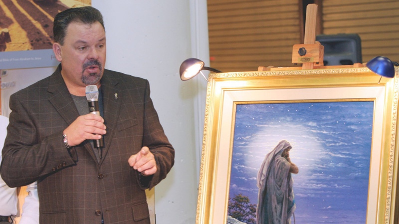 Artist Thomas Kinkade unveils his painting, "Prayer For Peace," at the opening of the exhibit "From Abraham to Jesus," Friday, Sept. 15, 2006, in Atlanta. 
