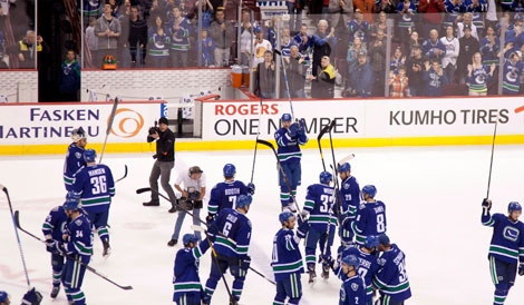 The Vancouver Canucks celebrate their win over the Edmonton Oilers and the winning of the Presidents Trophy at Rogers Arena in Vancouver, B.C. Saturday, April, 7, 2012. (THE CANADIAN PRESS/Jonathan Hayward)