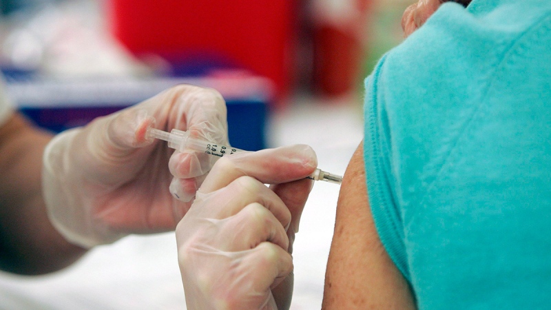 Walgreen's pharmacy manager Whitney Workman injects a costumer with the seasonal flu vaccine in Columbia, S.C., Sept. 1, 2009. (AP / Mary Ann Chastain)