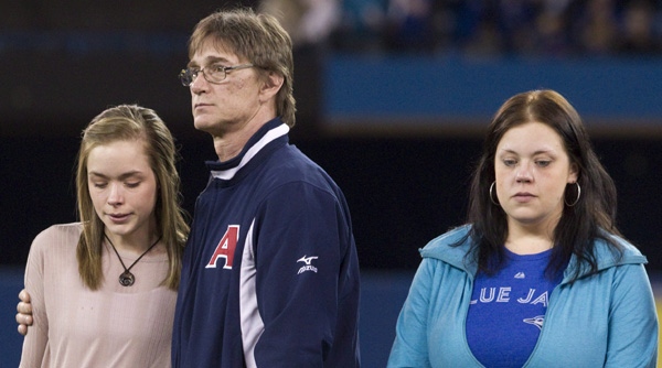Tanner Craswell's girlfriend Shanya Conway (left) is consoled by his father Keith Craswell (centre) as the Toronto Blue Jays honour ahead of their home opener against the Boston Red Sox in Toronto on Monday April 9, 2012 Tanner Craswell and Mitch Maclean, two P.E.I. baseball players who were murdered last year. The family's of Mitch MacLean (left) father Irwin MacLean, mother Dianne Maclean and brother Morgan MacLean and the family of Tanner Craswell, father Keith Craswell, sister Melissa Hall, sister Chantell Gillis, Shanya Conway (Tanner Craswell's girlfriend) brother Adam MacDonald and Katrina Abou Risk (his brother' girlfriend) were invited to the pitching mound, greeted by players and presented with signed shirts. THE CANADIAN PRESS/Chris Young