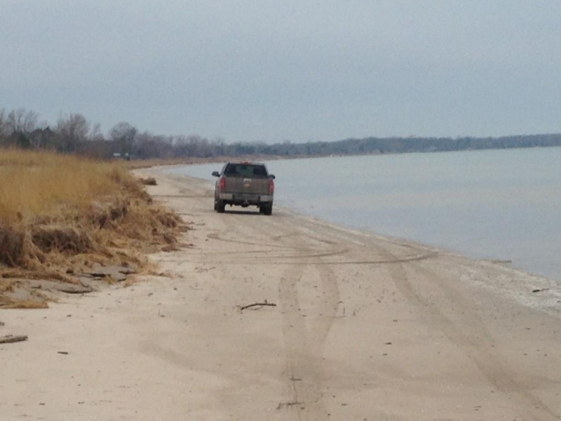 A vehicle drives on Ipperwash Beach along Lake Huron, east of Sarnia, Ont. on Friday, Dec. 5, 2014. (Bryan Bicknell / CTV London)