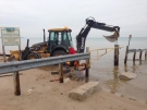A crew works to remove a barrier for vehicles on Ipperwash Beach, east of Sarnia, Ont. on Friday, Dec. 5, 2014. (Bryan Bicknell / CTV London)