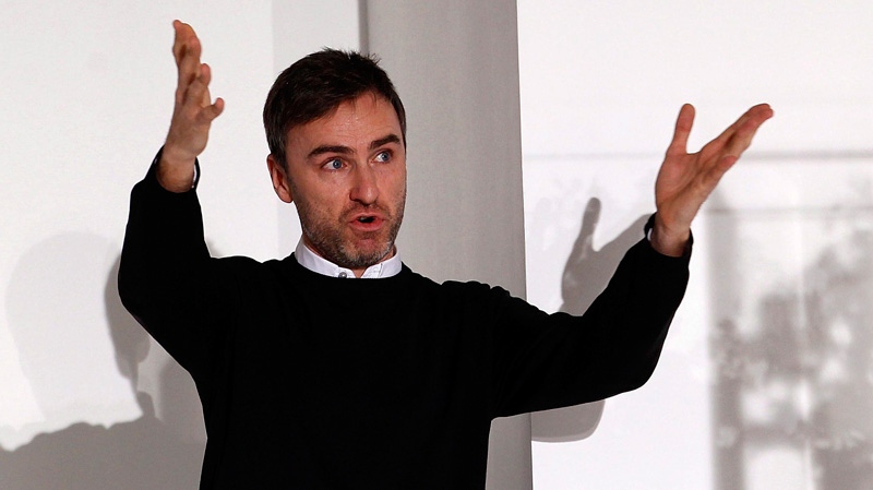 Belgian designer Raf Simons acknowledges the applause of the audience at the end of the Jil Sander Spring/Summer 2012 women's collection in Milan, in this Saturday, Sept. 25, 2011. (AP / Giuseppe Aresu)