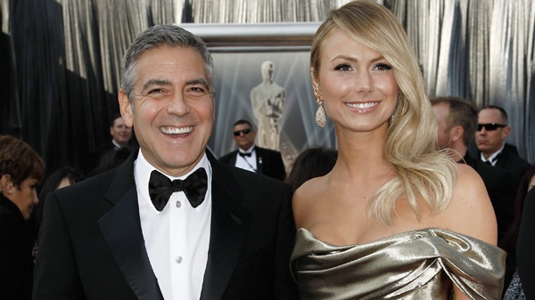 George Clooney, left, and Stacy Keibler arrive before the 84th Academy Awards on Sunday, Feb. 26, 2012, in the Hollywood section of Los Angeles. (AP / Matt Sayles)
