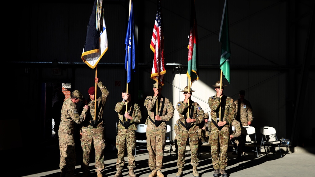 Honor guards at flag ceremony at Afghanistan base