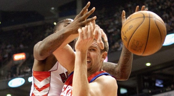 Philadelphia 76ers' Spencer Hawes (right) battles for the ball with Toronto Raptors' Ed Davis during first half NBA basketball action in Toronto on Wednesday April 11 , 2012. THE CANADIAN PRESS/Chris Young