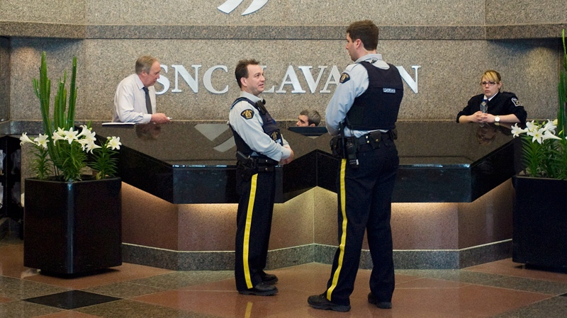 RCMP officers are shown in the lobby of SNC Lavalin in Montreal, Friday, April 13, 2012. (Graham Hughes / THE CANADIAN PRESS)