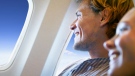 Airlines passengers look out the window in this file photo. (Yuri Arcurs/shutterstock.com)