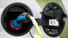 An electric plug charges a Smart Car electric drive vehicle in New York on July 14, 2010. (AP / Mark Lennihan)