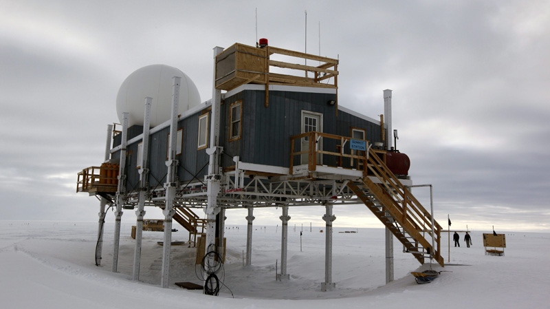 In this Friday, July 15, 2011 photo, scientists walk on the snow surrounding Summit Station, a small research facility situated 10,500 feet above sea level, on top of the Greenland ice sheet. (AP Photo/Brennan Linsley)