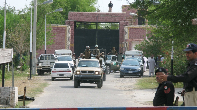 Pakistani army troops escort security officials visited the central jail in Bannu, Pakistan, Monday, April 16, 2012. (AP / Ijaz Muhammad)