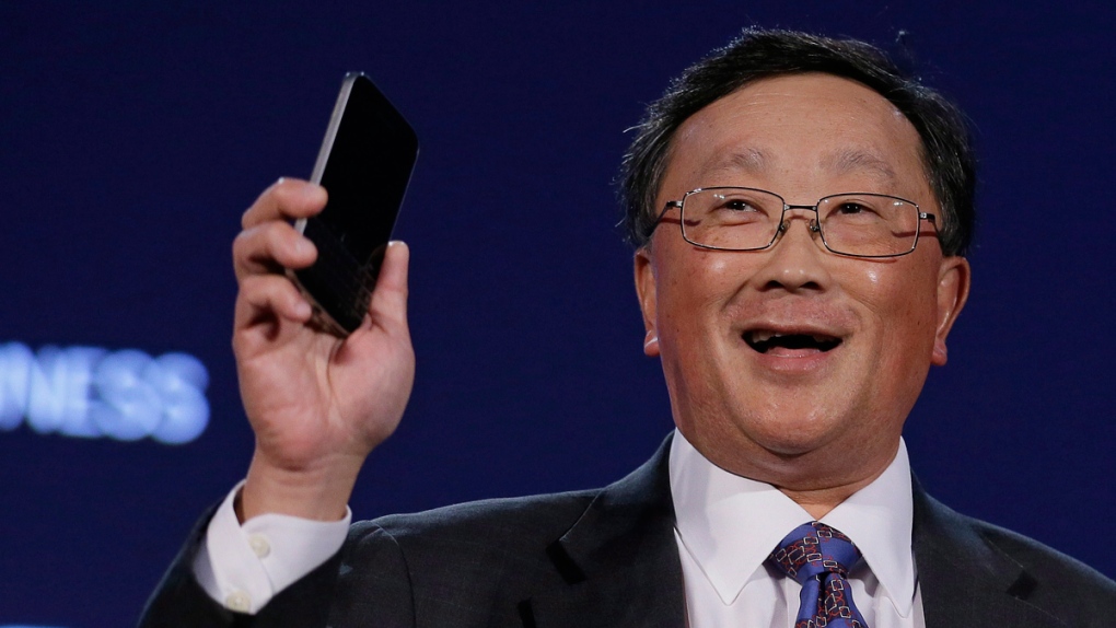 John Chen holds a Blackberry Classic