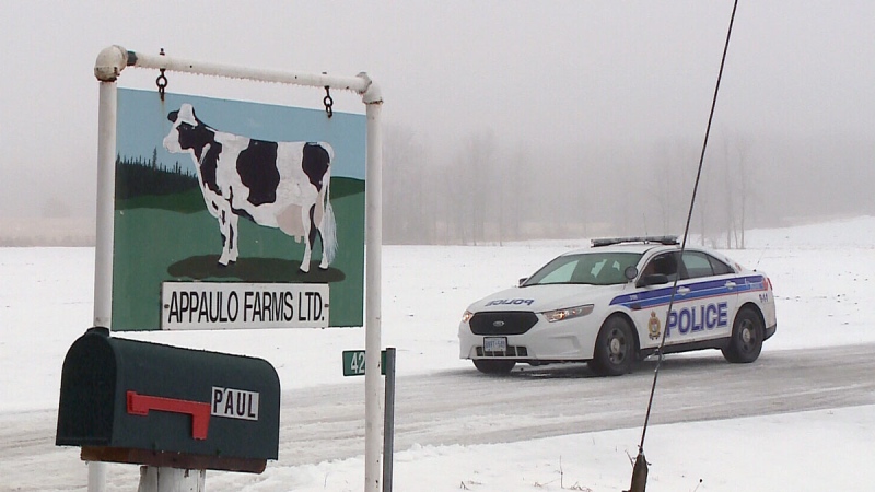  A police car sits in the laneway of a farm in Carp, Ont.  where a 69-year-old farmer suffered horrible injuries while installing equipment on his tractor on Wednesday, Dec. 17, 2014. 