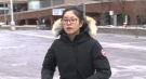 Kaiwen Qian, a University of Waterloo student accused of paying a man more than $900 to write an exam for her, walks outside the Kitchener courthouse on Wednesday, Dec. 17, 2014.