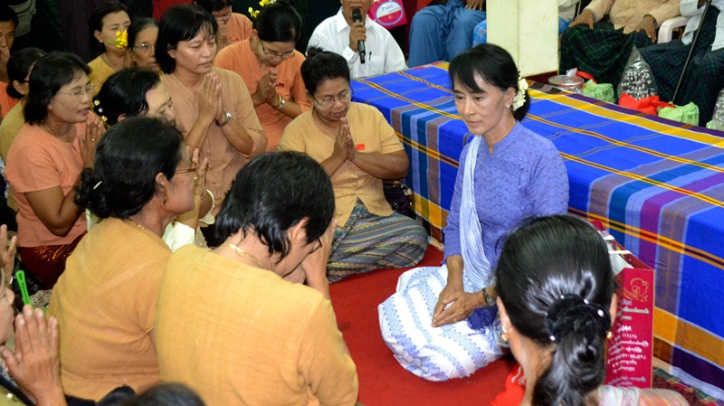Myanmar democracy leader Aung San Suu Kyi, center, receives gestures of respect from members of her National League for Democracy party during a ceremony honoring the elderly at the party's headquarters Wednesday, April 18, 2012, in Yangon, Myanmar. (AP / Khin Maung Win)