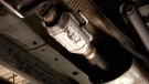 A catalytic converter is seen under a vehicle in this undated image taken from video.