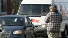An Ottawa police officer disguised as a panhandler helps catch drivers texting behind the wheel Thursday, April 19, 2012. 