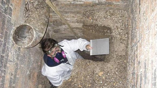 A researcher is seen collecting samples of bird droppings found in a chimney at Queen's University in Kingston, Ont. in this undated image. (Chris Grooms, Queen's University)