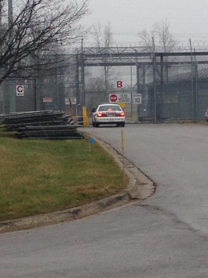 A police cruiser sits at the gates of the Elgin-Middlesex Detention Centre in London, Ont. on Tuesday, Dec. 23, 2014. (Cristina Howorun / CTV London)