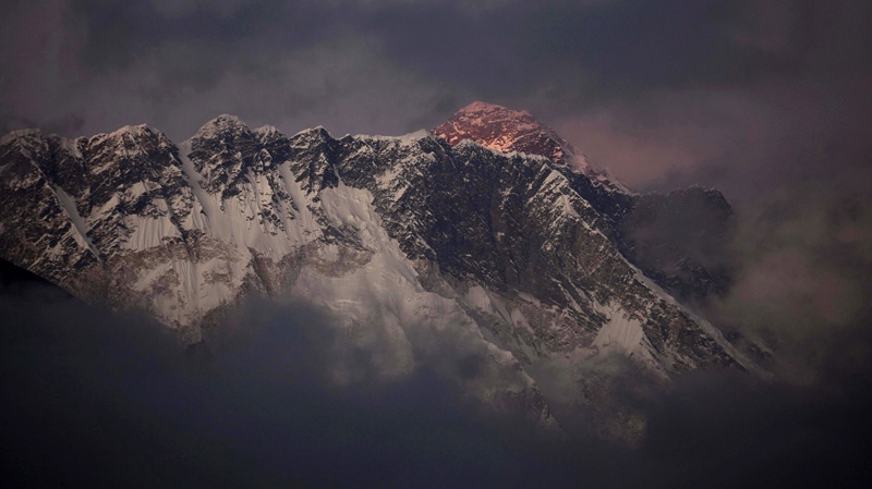 In this Oct. 27, 2011 file photo, the last light of the day sets on Mount Everest as it rises behind Mount Nuptse as seen from Tengboche, in the Himalaya's Khumbu region, Nepal. 