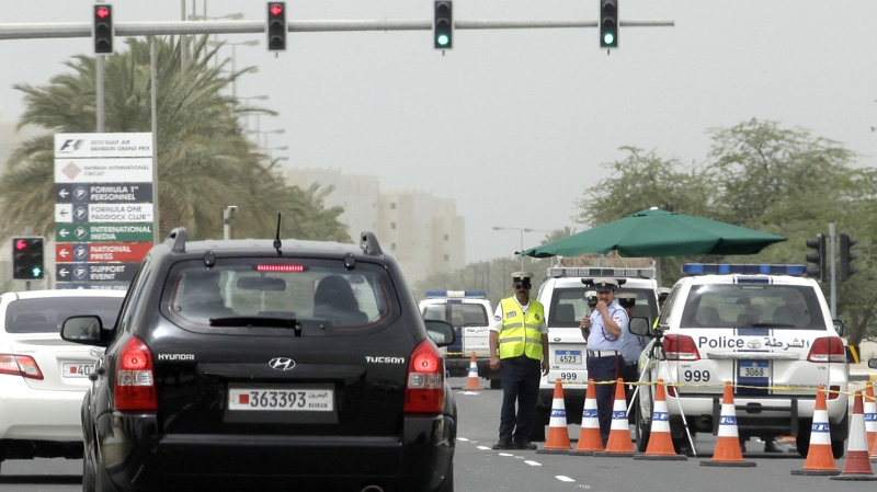 Police officers man a checkpoint outside the Formula One Bahrain International Circuit in Sakhir, Bahrain, Sunday, April 22, 2012. Security remained tight amid expectations of fresh anti-government protests on race day of the Formula One Bahrain Grand Prix. (AP Photo/Hassan Ammar)