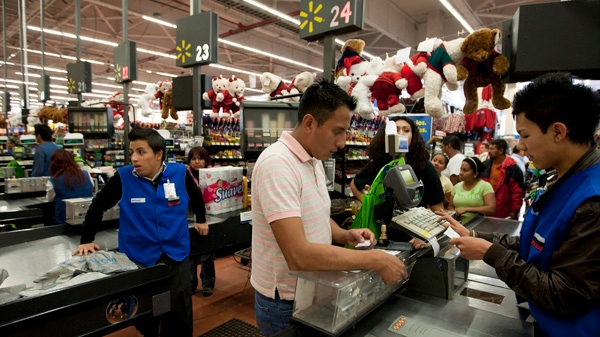 A man pays at the cash register at a Wal-Mart Superstore in Mexico City in this Nov. 18, 2011 photo. (AP Photo)