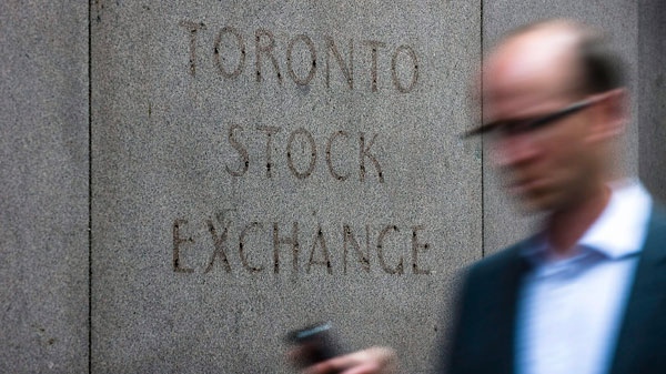 A man walks past a building in Toronto that used to house the Toronto Stock Exchange on Thursday, August 18 2011. (Aaron Vincent Elkaim / THE CANADIAN PRESS)