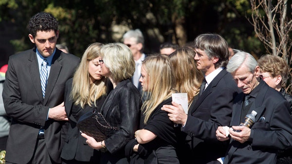 Friends and family of Nik Zoricic embrace each other following his funeral in Toronto on Monday, March 19, 2012. (Pawel Dwulit / THE CANADIAN PRESS)