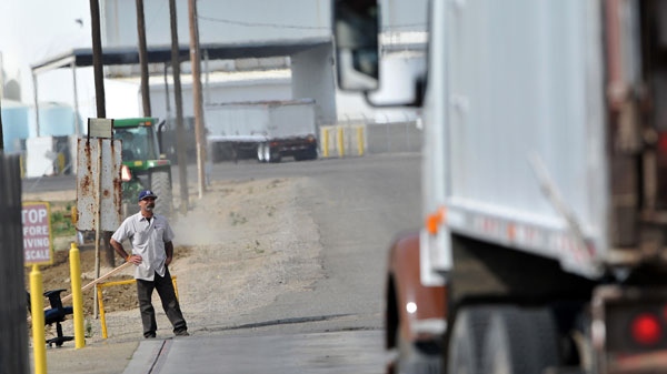 A truck leaves the plant at Baker Commodities transfer station where a cow with mad cow disease was discovered in Hanford, California, Tuesday, April 24, 2012. (AP / The Fresno Bee, John Walker )