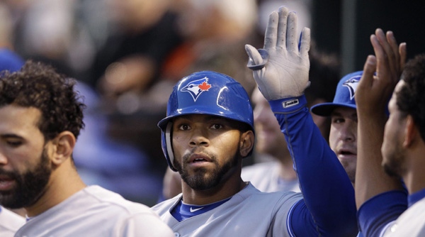 Toronto Blue Jays' Eric Thames high-fives teammates after hitting a solo home run in the third inning of a baseball game against the Baltimore Orioles in Baltimore, Tuesday, April 24, 2012. (AP Photo/Patrick Semansky)