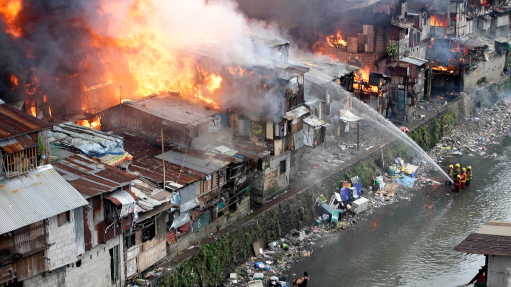 Burning houses along a creek in Quezon city