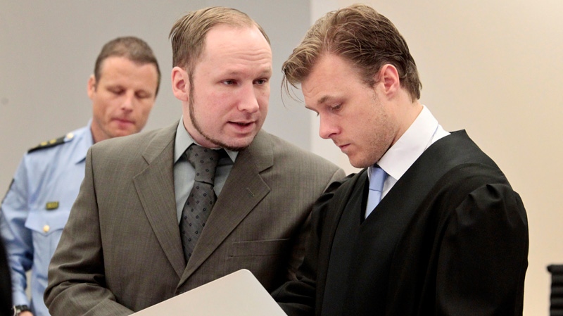 Accused Anders Behring Breivik talks with a member of his defence team Tord Jordet, right, in the courtroom in Oslo, Wednesday, April 25, 2012. (AP / Hakon Mosvold Larsen)