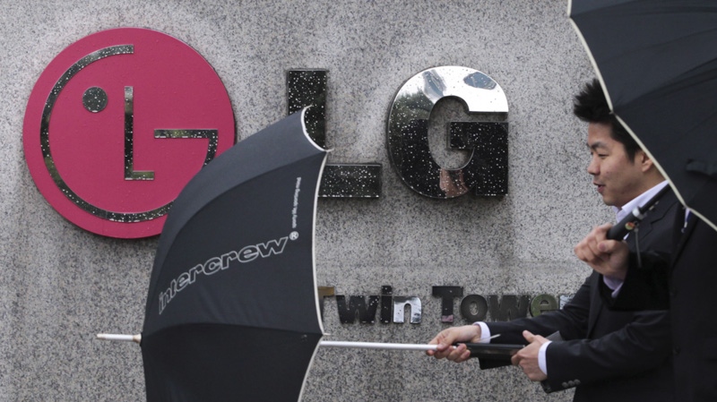 A South Korean man walks by a logo of LG Electronics Inc. in front of the company's headquarters in Seoul, South Korea, Wednesday, April 25, 2012. (AP Photo/Ahn Young-joon)