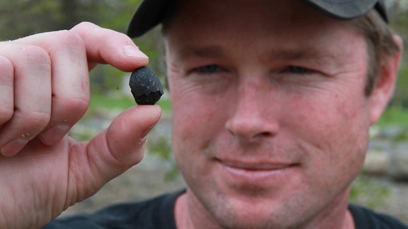 Robert Ward displays one of two pieces of a meteorite he found at a park in Lotus, Calif., Wednesday, April 25, 2012. (AP / Rich Pedroncelli)