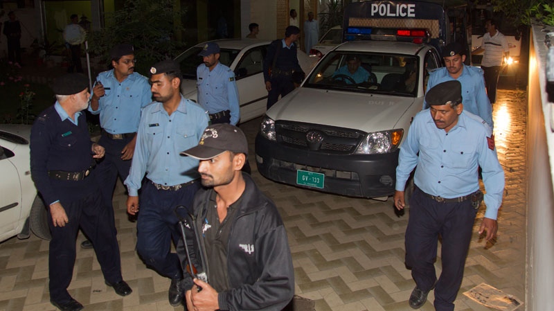 Police officers escort a vehicle carrying the family of Osama bin Laden, in Islamabad, Pakistan on Thursday, April 26, 2012. (AP / B.K. Bangash)