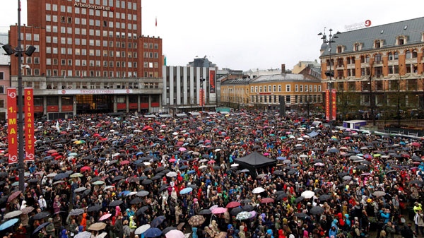 Some 40,000 people stand in drizzling rain to participate in the singing of "Barn av Regnbuen" (Children of the Rainbow) in Youngstorget square, Oslo, Norway, Thursday, April 26, 2012. (Kyrre Lien / NTB Scanpix) 