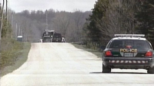 OPP vehicles block the area near the site of a fatal standoff in Chatsworth Township, Ont. on Friday, April 27, 2012.