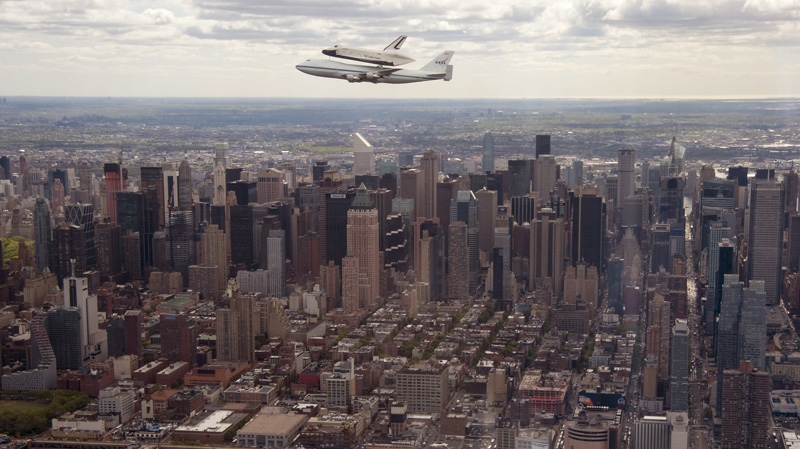 In this photo provided by NASA, Space shuttle Enterprise, riding on the back of the NASA 747 Shuttle Carrier Aircraft, flies over New York on Friday, April 27, 2012. (AP Photo/NASA, Robert Robert Markowitz)