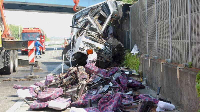 The wreckage of a destroyed bus is left on a highway in Fujioka, Gunma prefecture, north of Tokyo Sunday, April 29, 2012. (AP Photo/Kyodo News) 