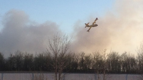 Water bombers helped douse the flames at a Selkirk scrap yard so firefighters could get closer to the blaze to fight it.(Holly Caruk / CTV News)